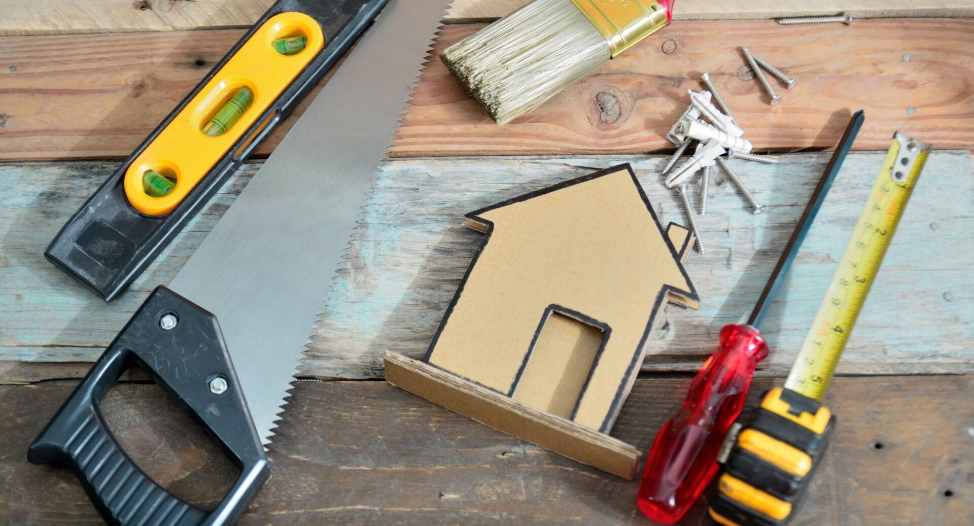 Home repair supplies. Saw, scewdriver, leveler, paintbrush, tape measure