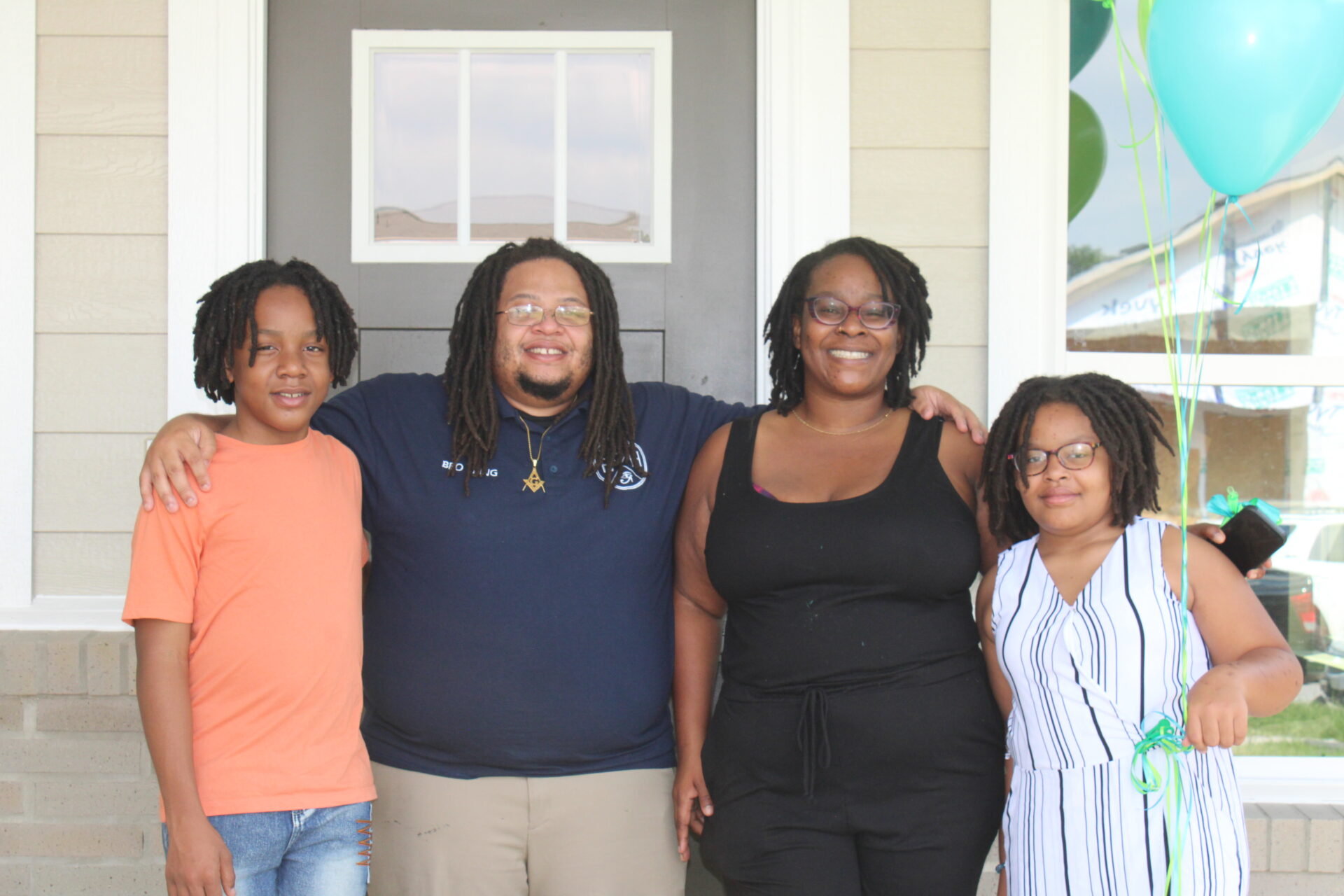 Houston Habitat Family Partner standing in front of their new home