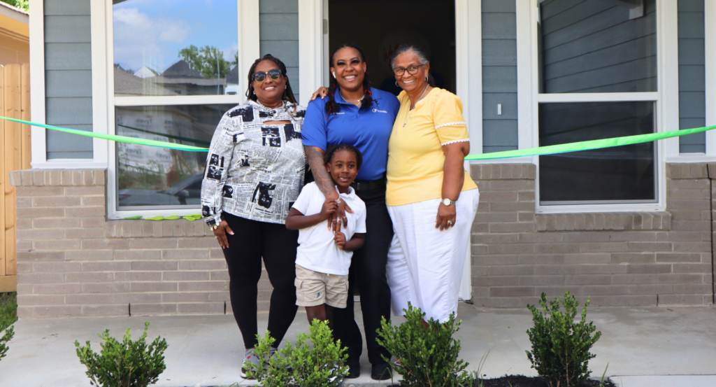 Family partner stand in front of home with their support system